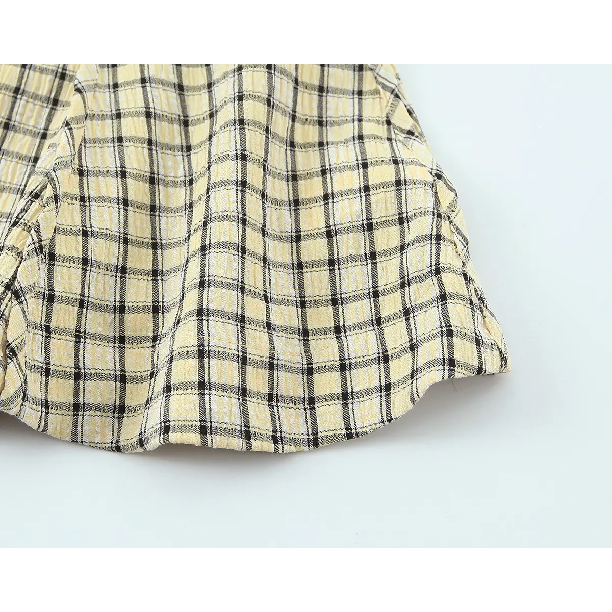 Close up of yellow black plaid textured fabric and pattern detail
