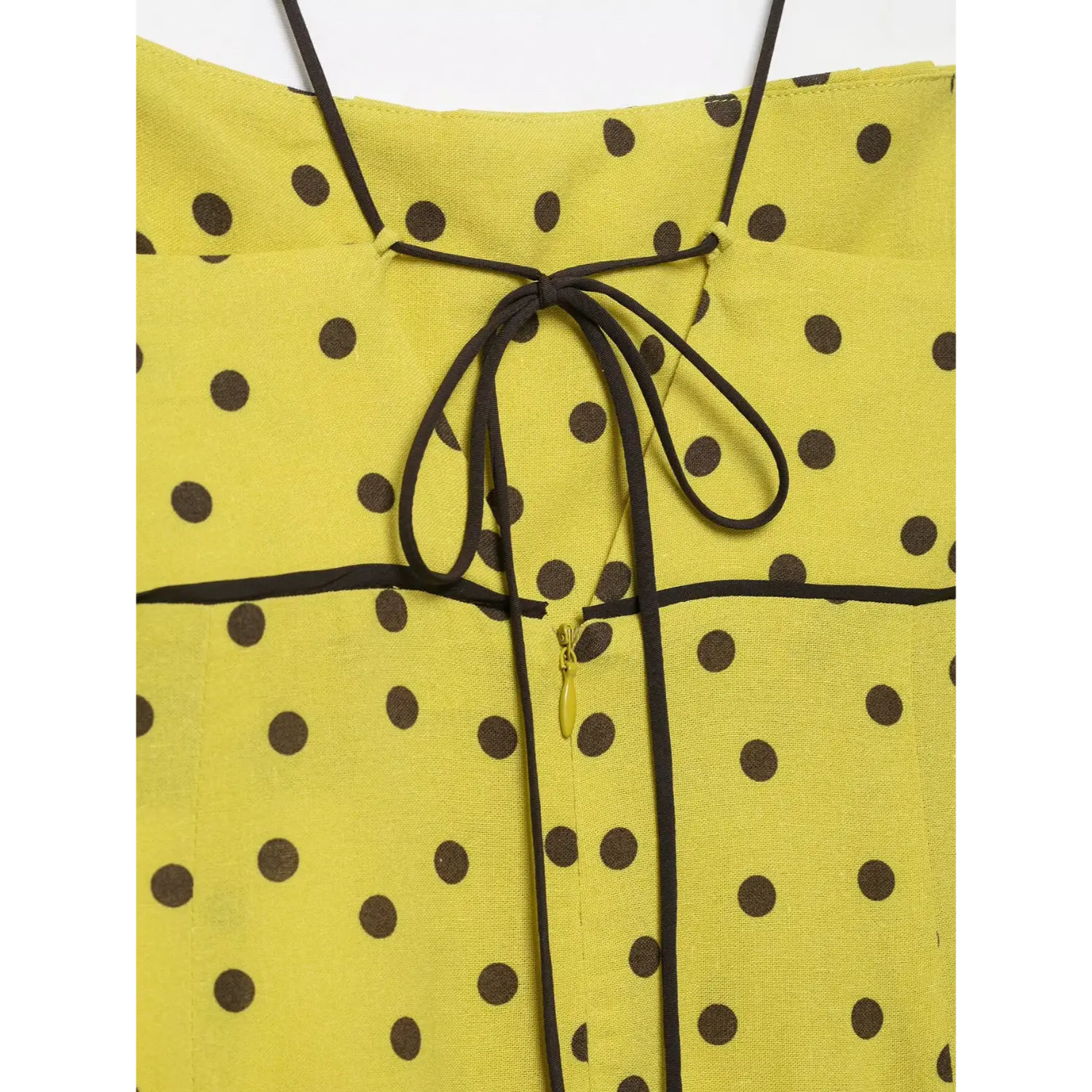 Back view close-up, self tie bow and invisible zipper on yellow brown polka dot spaghetti strap midi dress