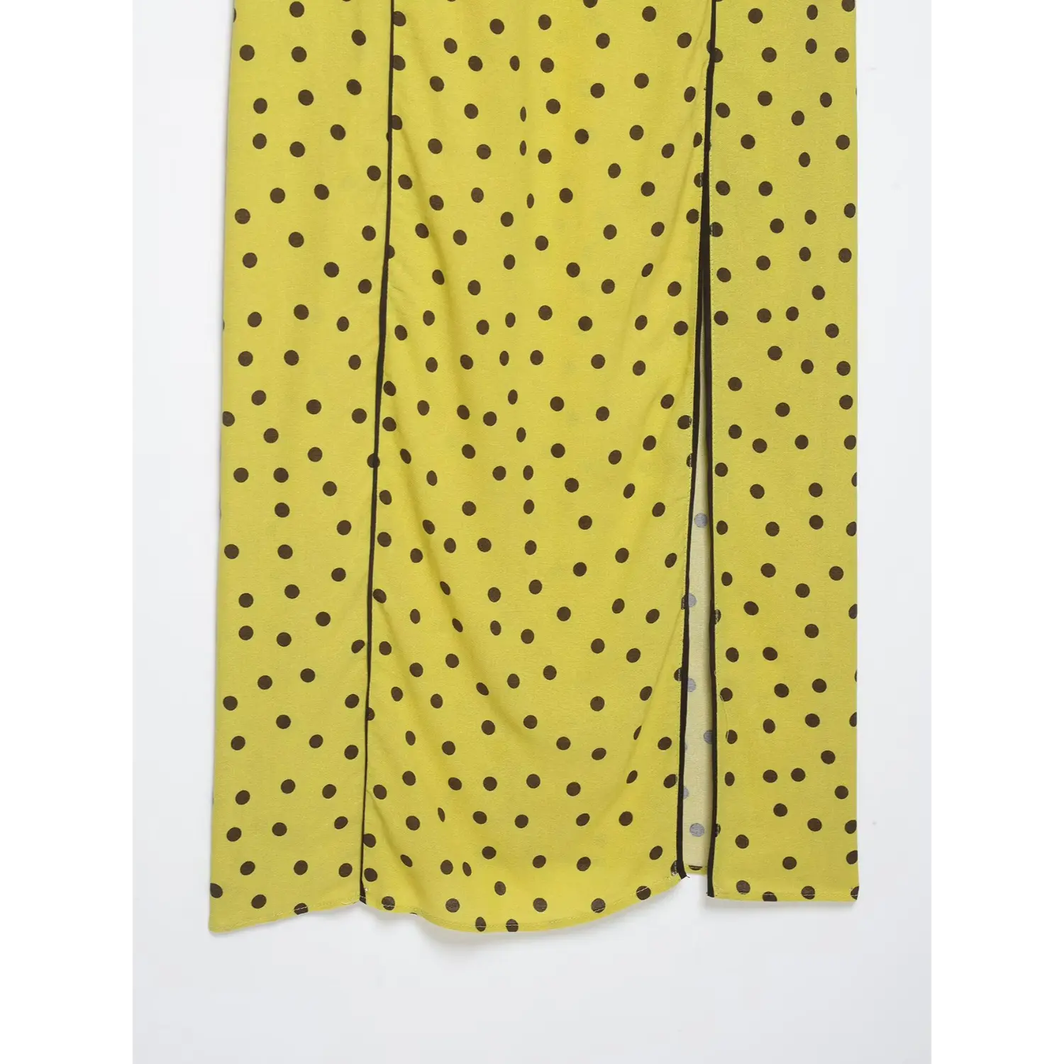 Full length close-up of side front slit with black piping on yellow brown polka dot midi dress