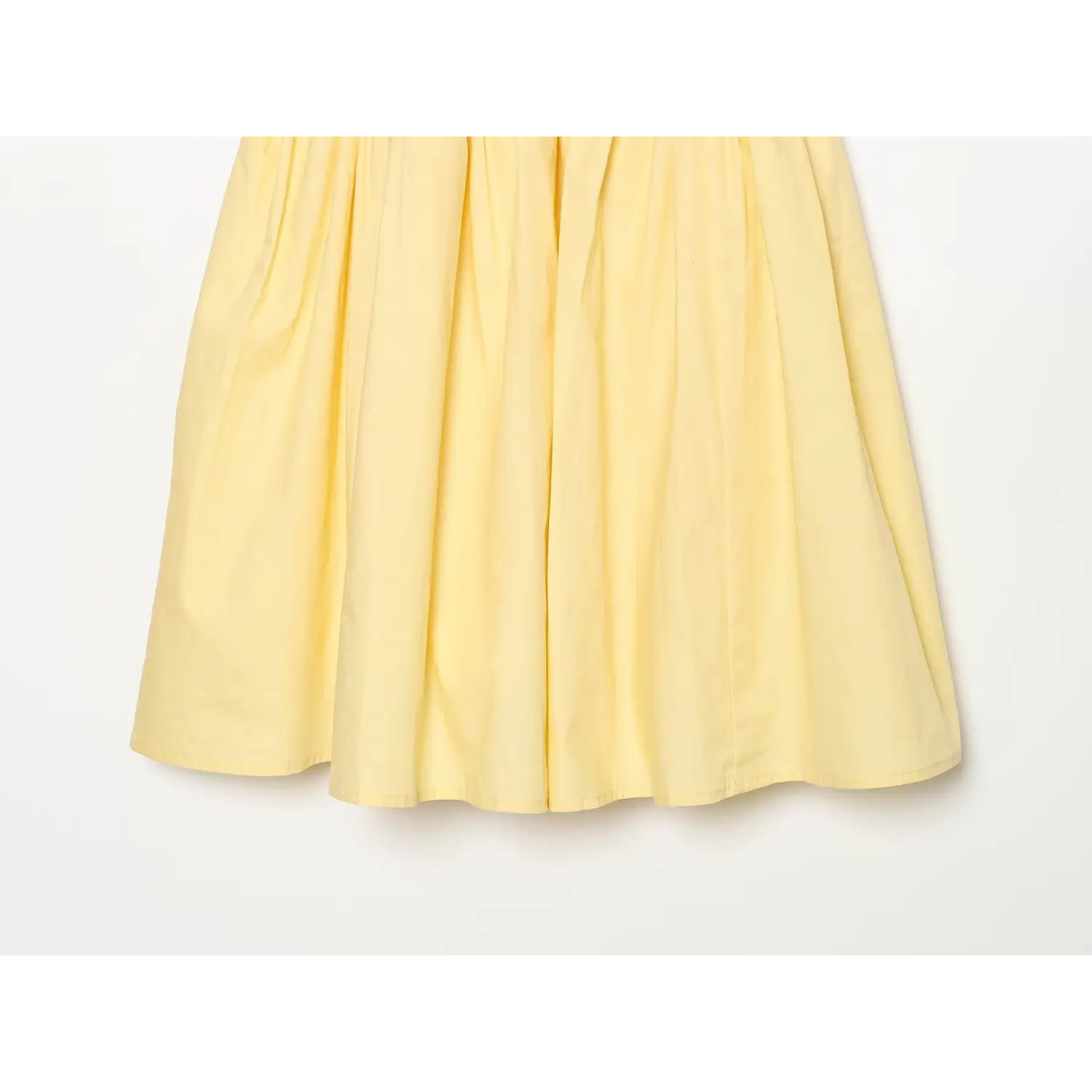 Partial shot of yellow cami dress flowy a‑line mini skirt with soft gathers
