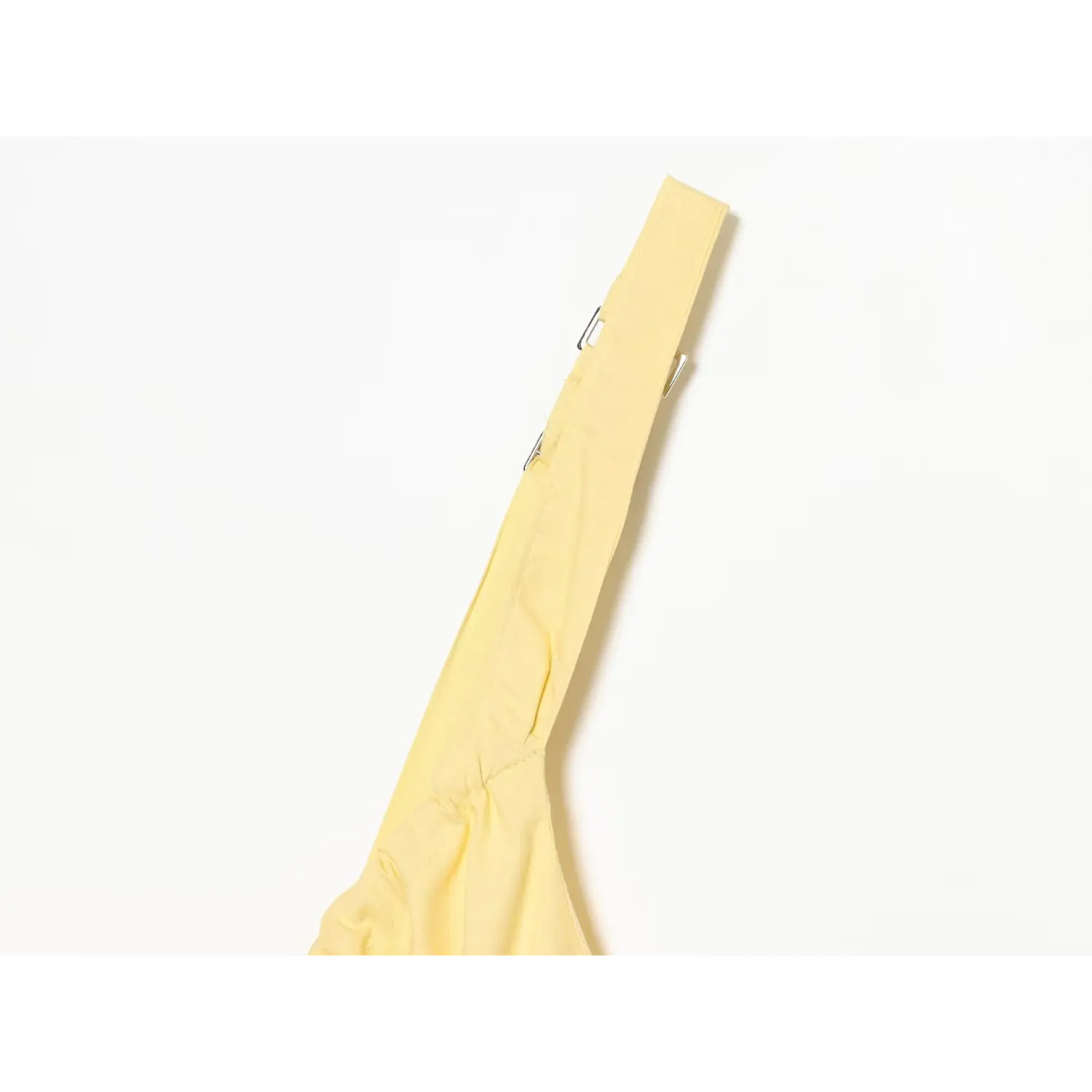 Close‑up of yellow cami dress adjustable metal buckle shoulder strap detail