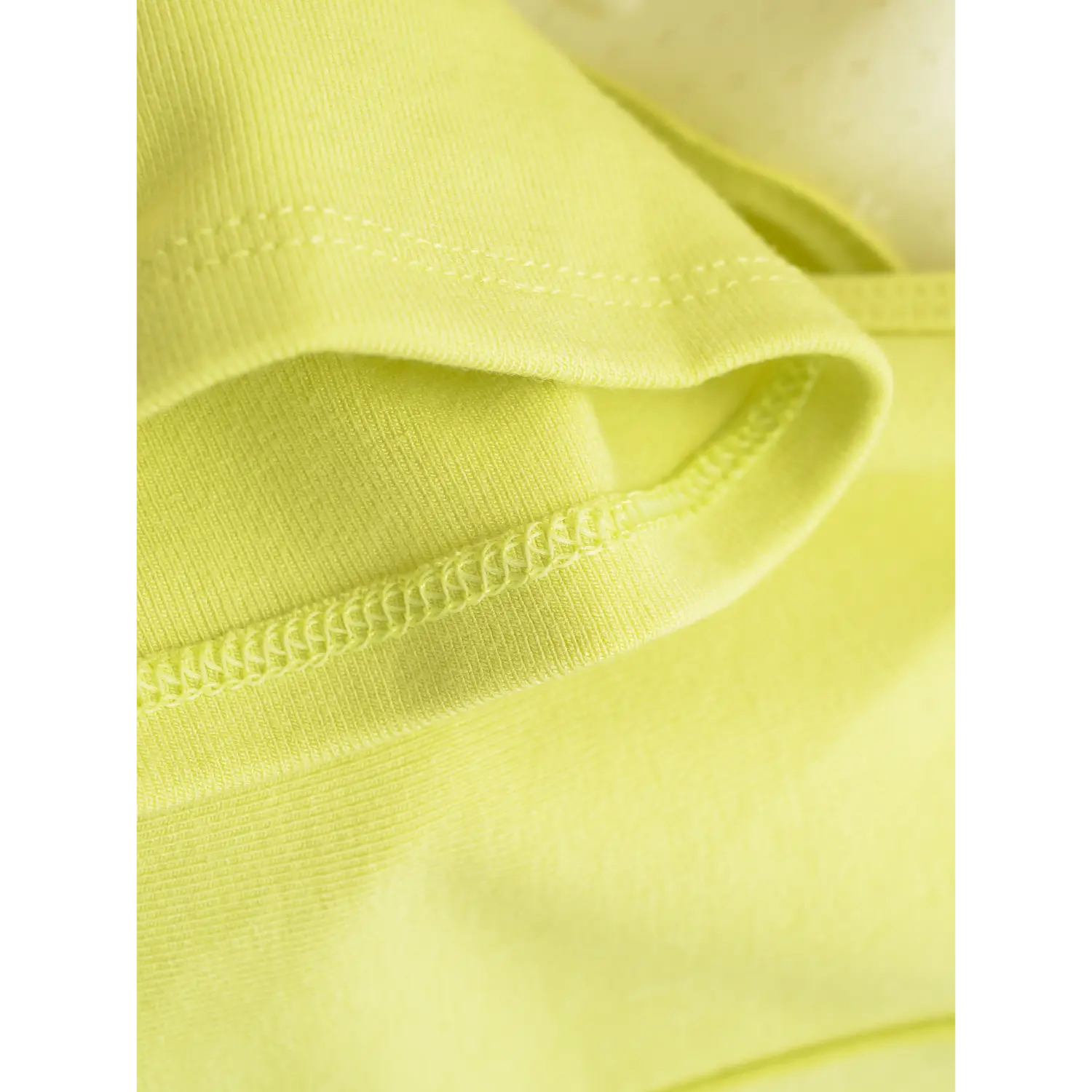 Yellow backless tank hem flat close-up, high elastic wavy overlock fine rib knit edge cropped curved cut white background shot