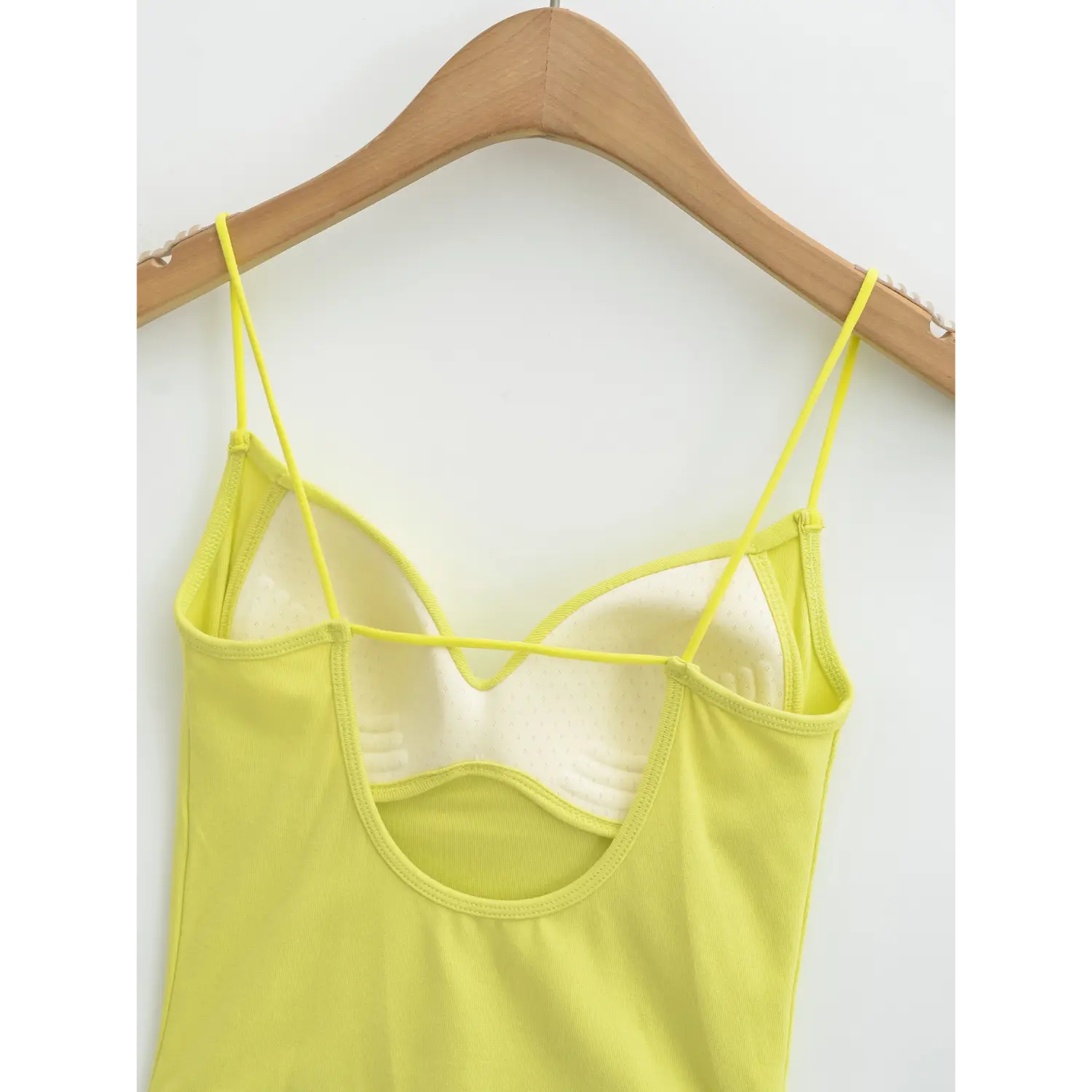 Yellow backless camisole u open back inner flat close-up, cross chest thin tie strap wide u back binding full breathable padded lining white background shot