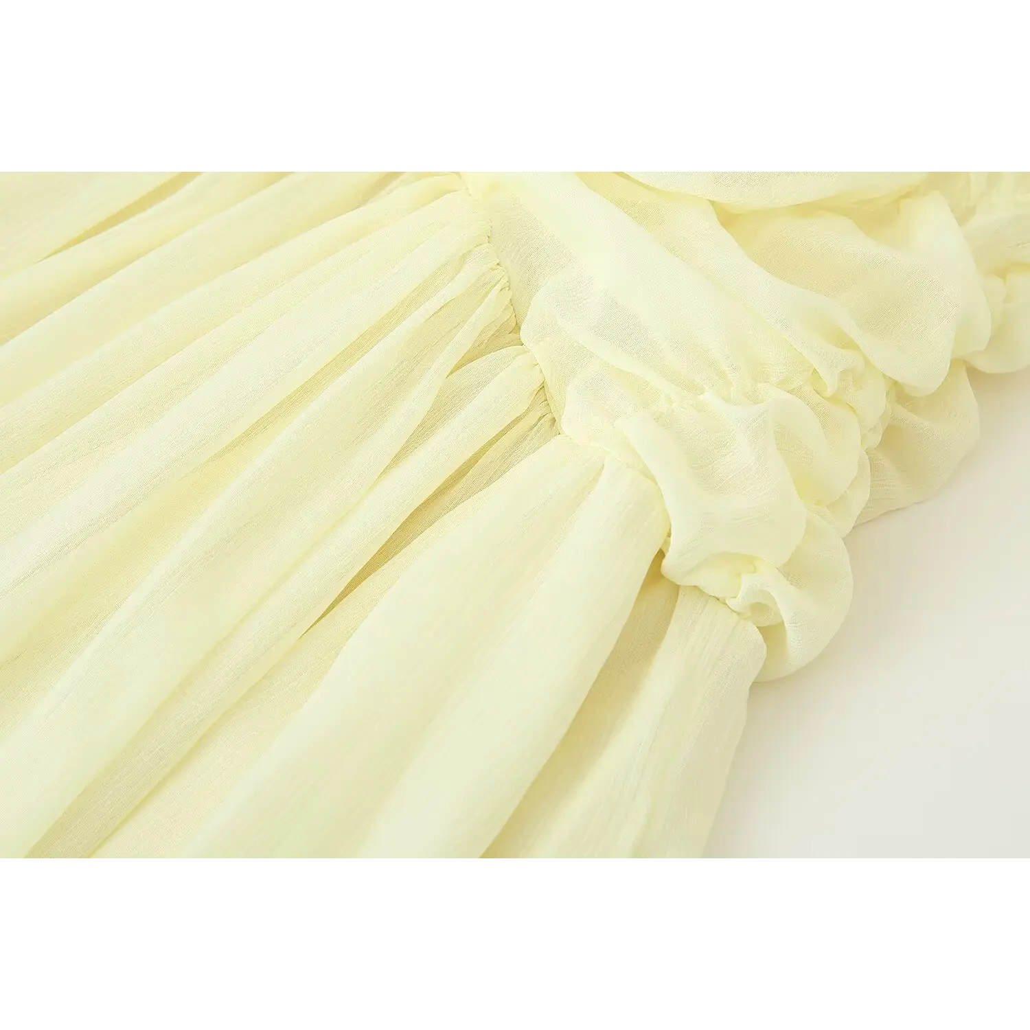 Waist hip junction close-up pale yellow chiffon dress, gathered ruched waist transition to full pleated flow midi skirt, soft crinkle sheer fabric