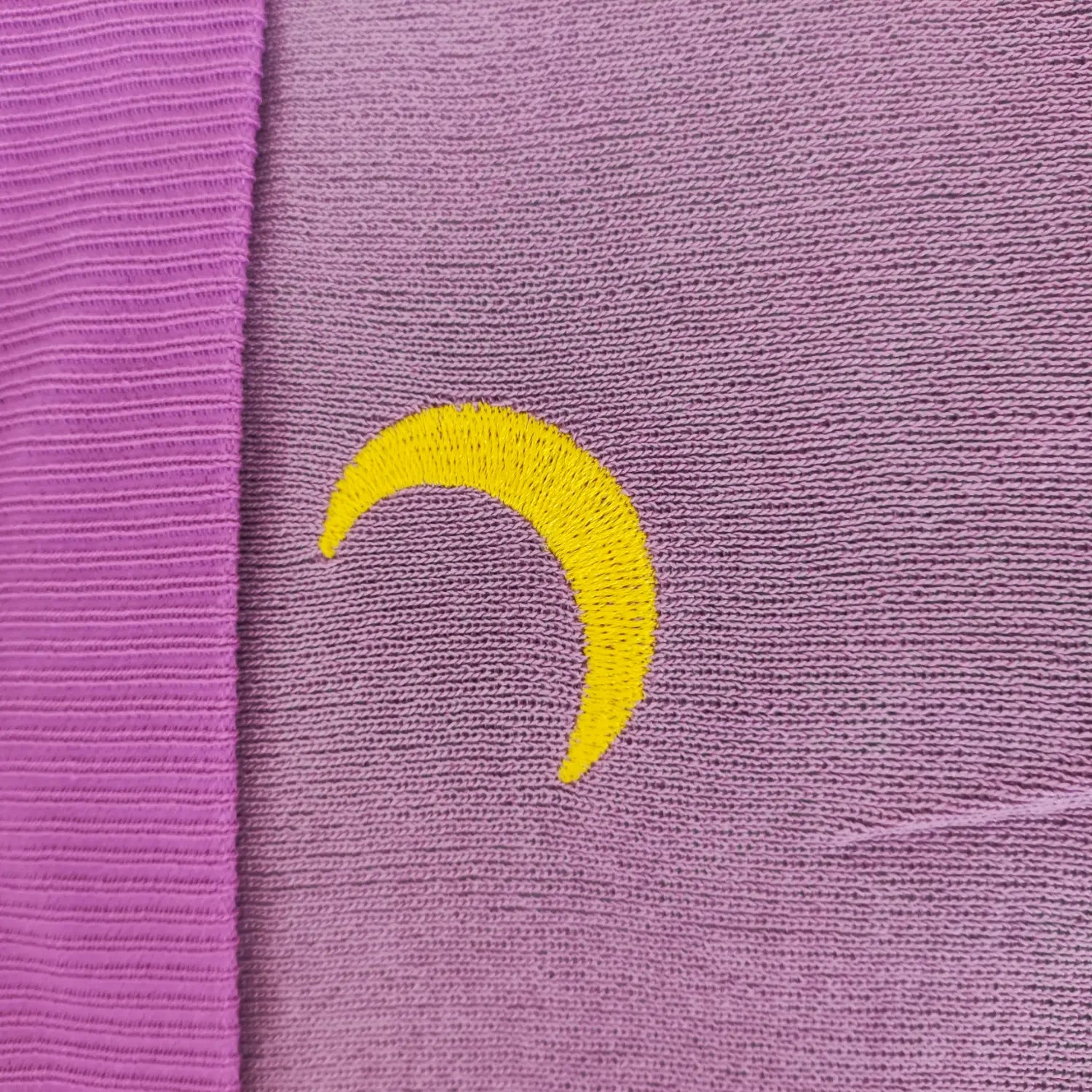 Close‑up shot yellow crescent moon embroidery detail on purple ribbed knit tube top