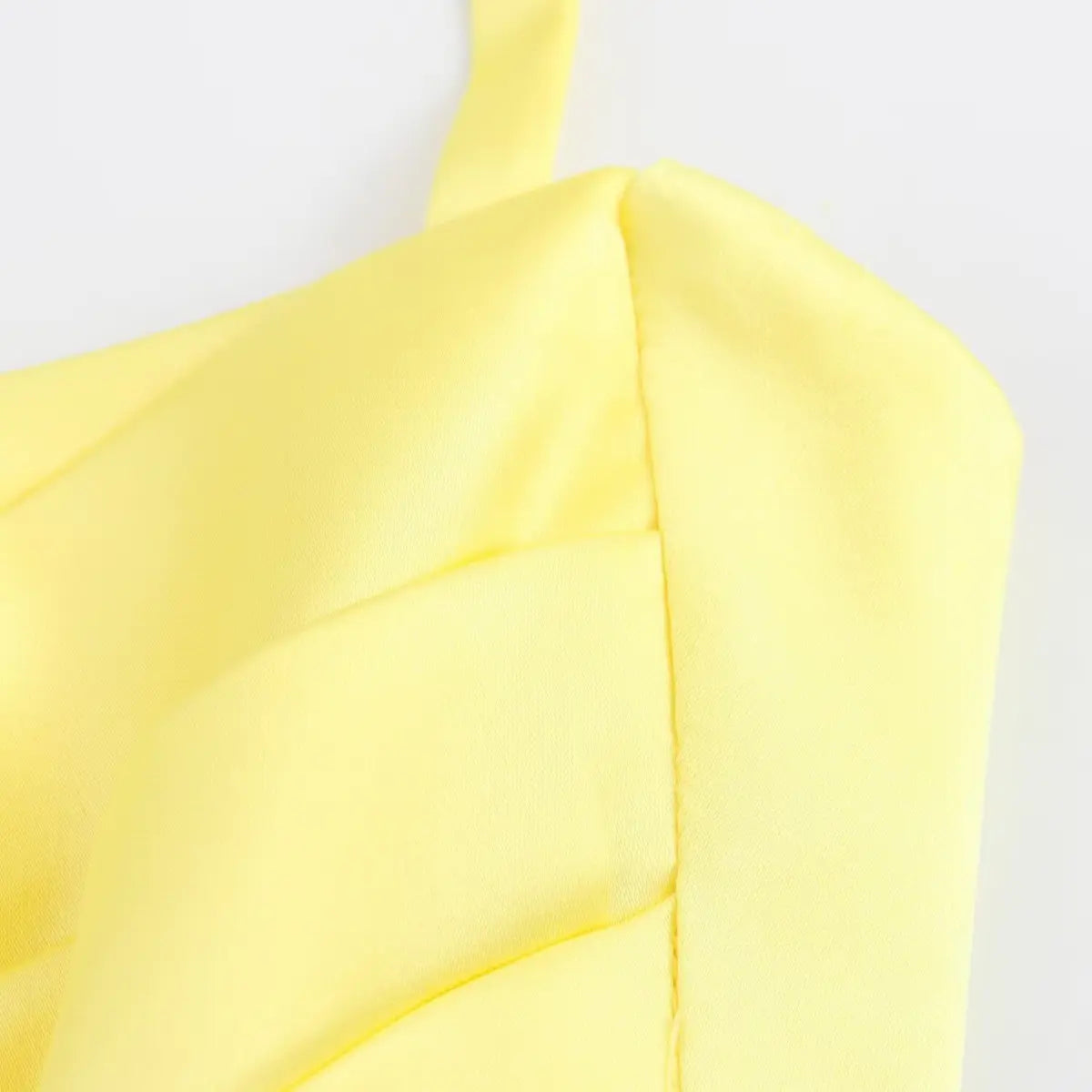 Close-up of the dress's bodice, showcasing the stitching on the ruched front panel.