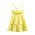 Front view of a bright yellow mini dress with spaghetti straps, crisscross back, ruched bodice, waist cutouts, and tiered ruffled skirt.