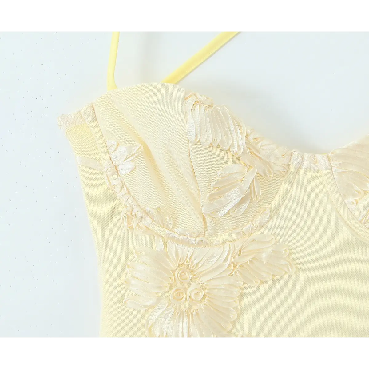 Close-up of the sweetheart neckline, molded cups, and textured floral embroidery.