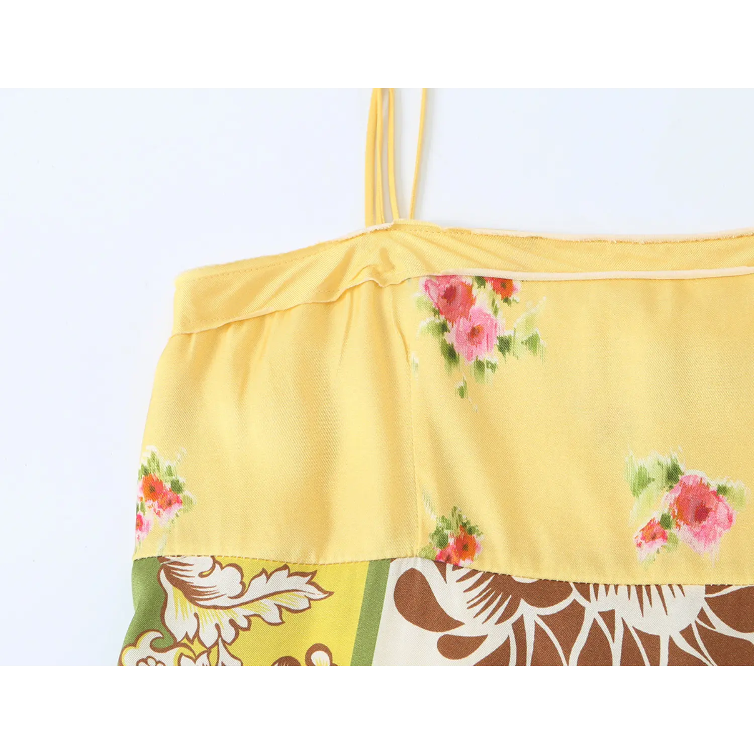Macro fabric detail of pink floral print yellow bodice section on vintage cami midi dress