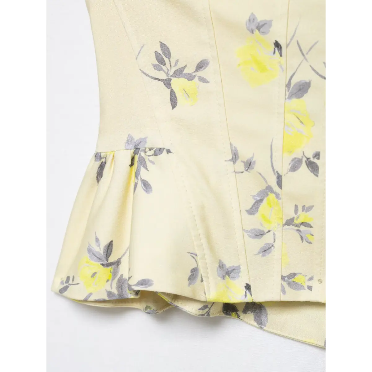 Close-up of the side seam and peplum ruffle on yellow floral corset camisole