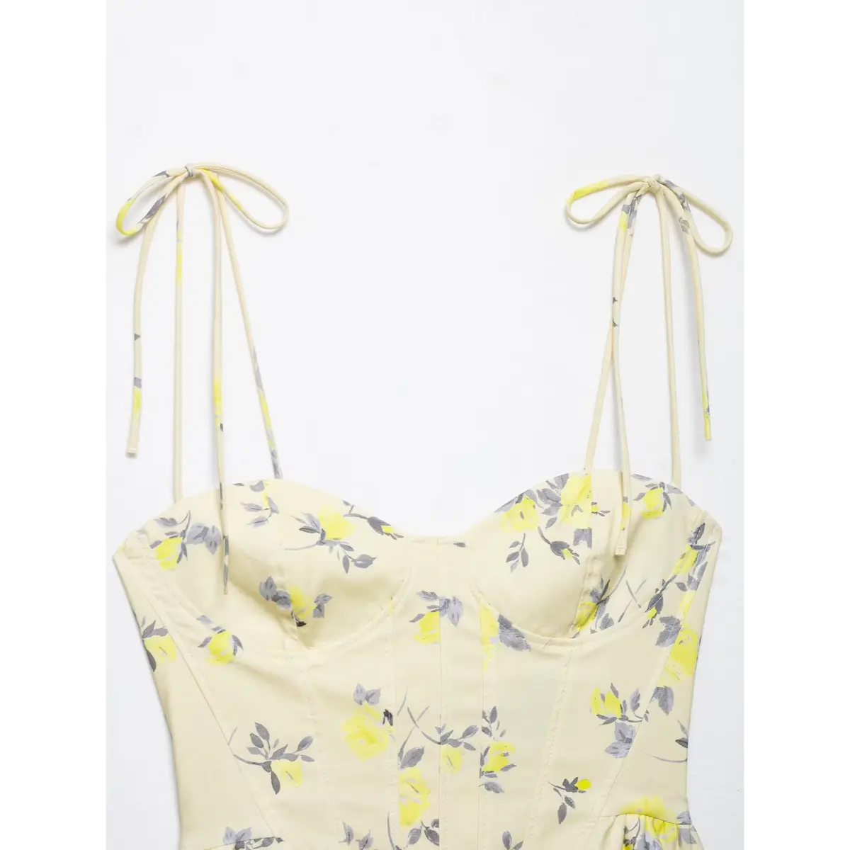 Close-up of tie straps and sweetheart neckline on yellow floral print corset camisole