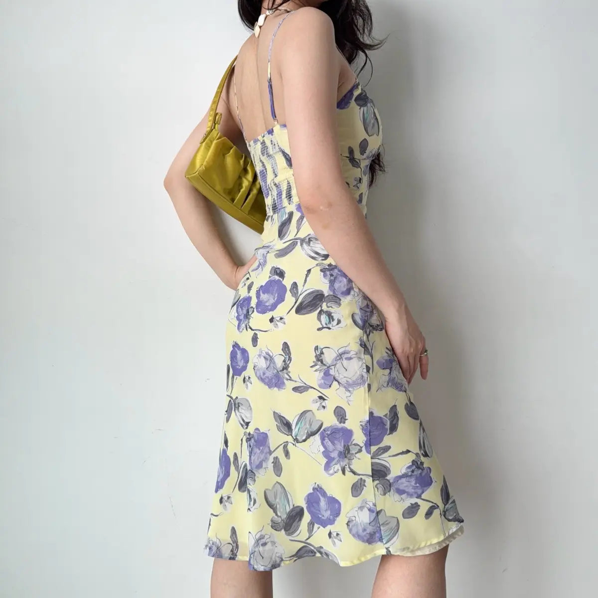 Back view of the yellow floral midi dress, showing the smocked panel.