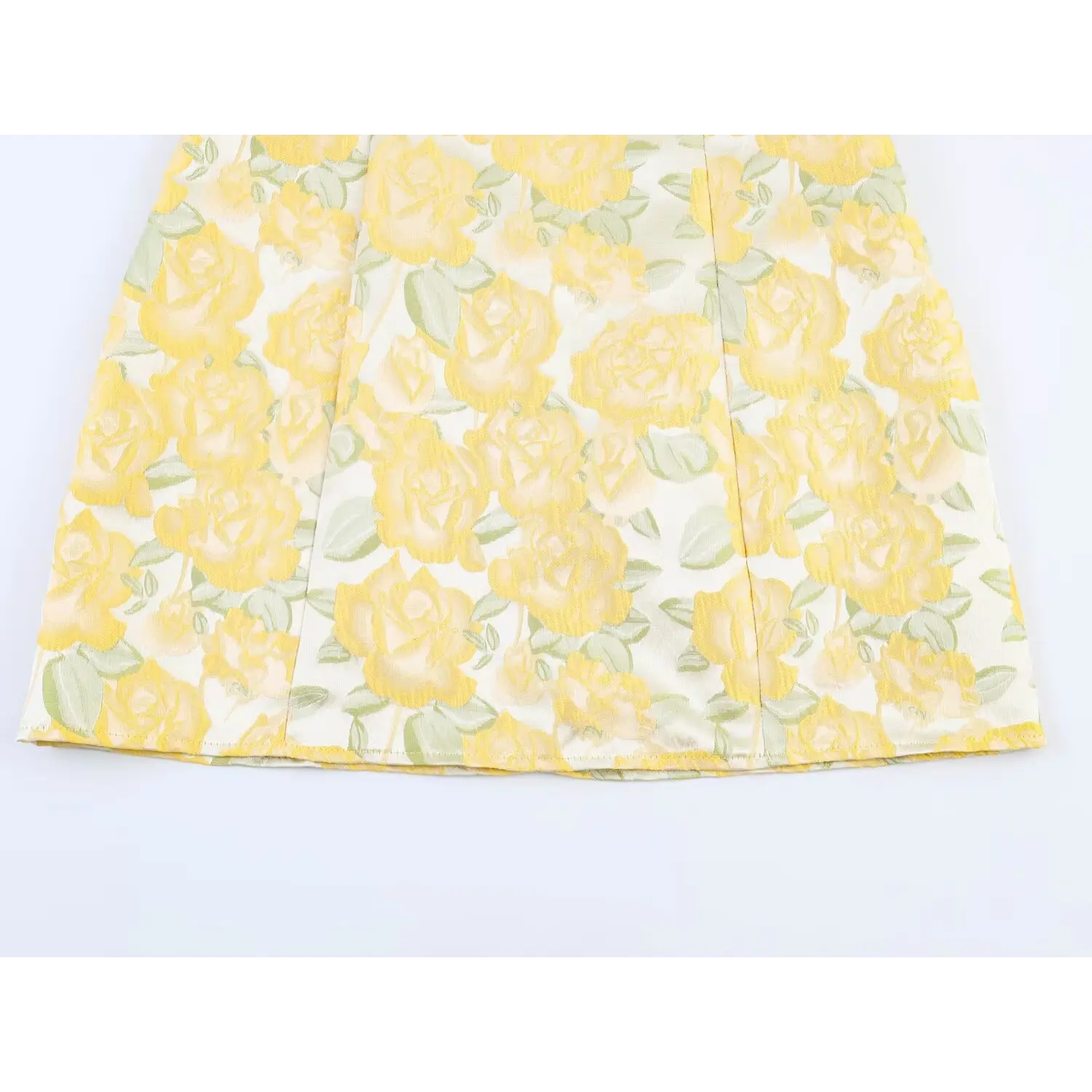 Close-up of skirt vertical princess seams and yellow rose printed textured fabric