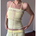 Front lifestyle shot pale yellow convertible halter knit tube top, ruffle trim front pink drawstring, cropped slim fit