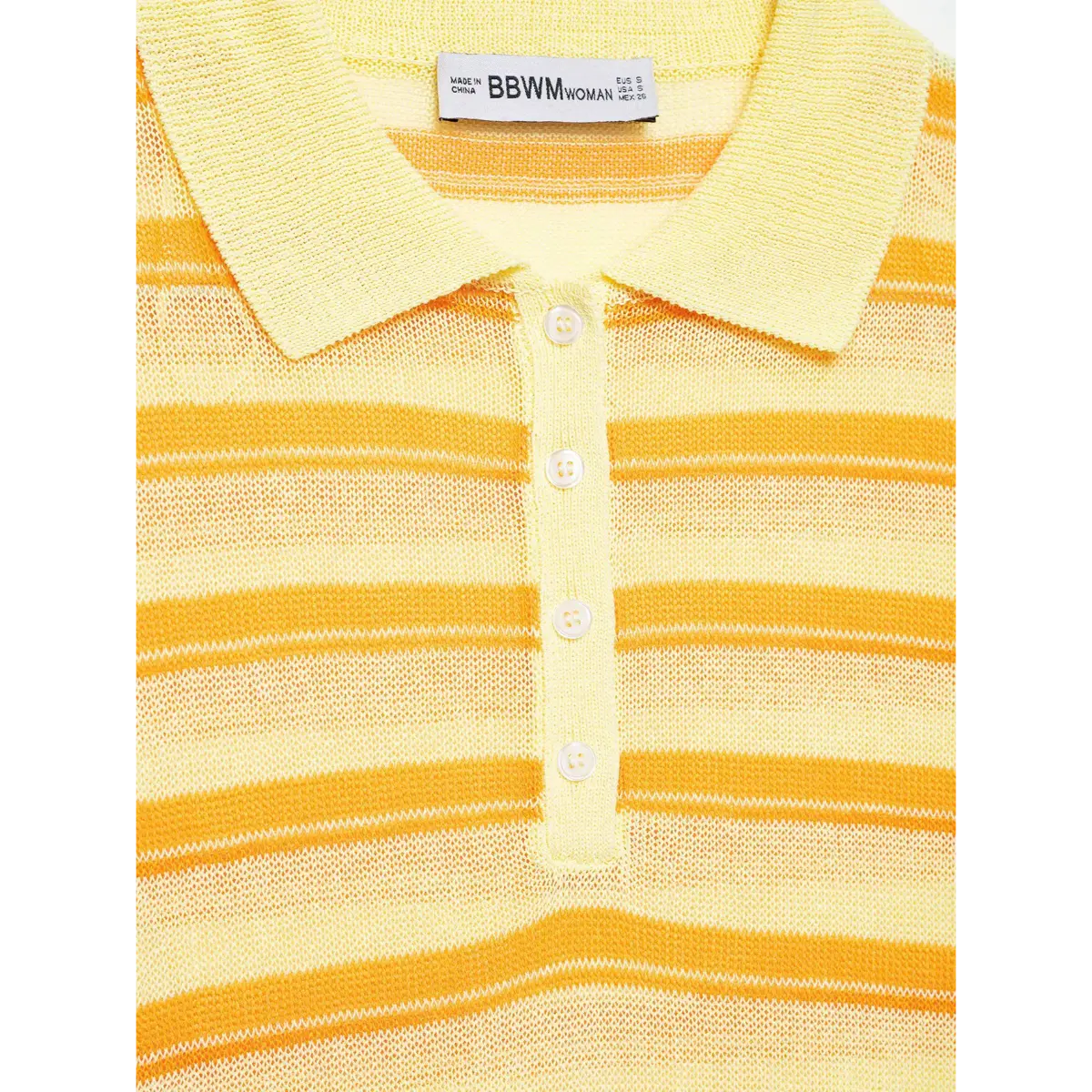Close-up detail of the four-button placket, neck label, and collared neckline on a yellow and orange striped knit polo top.