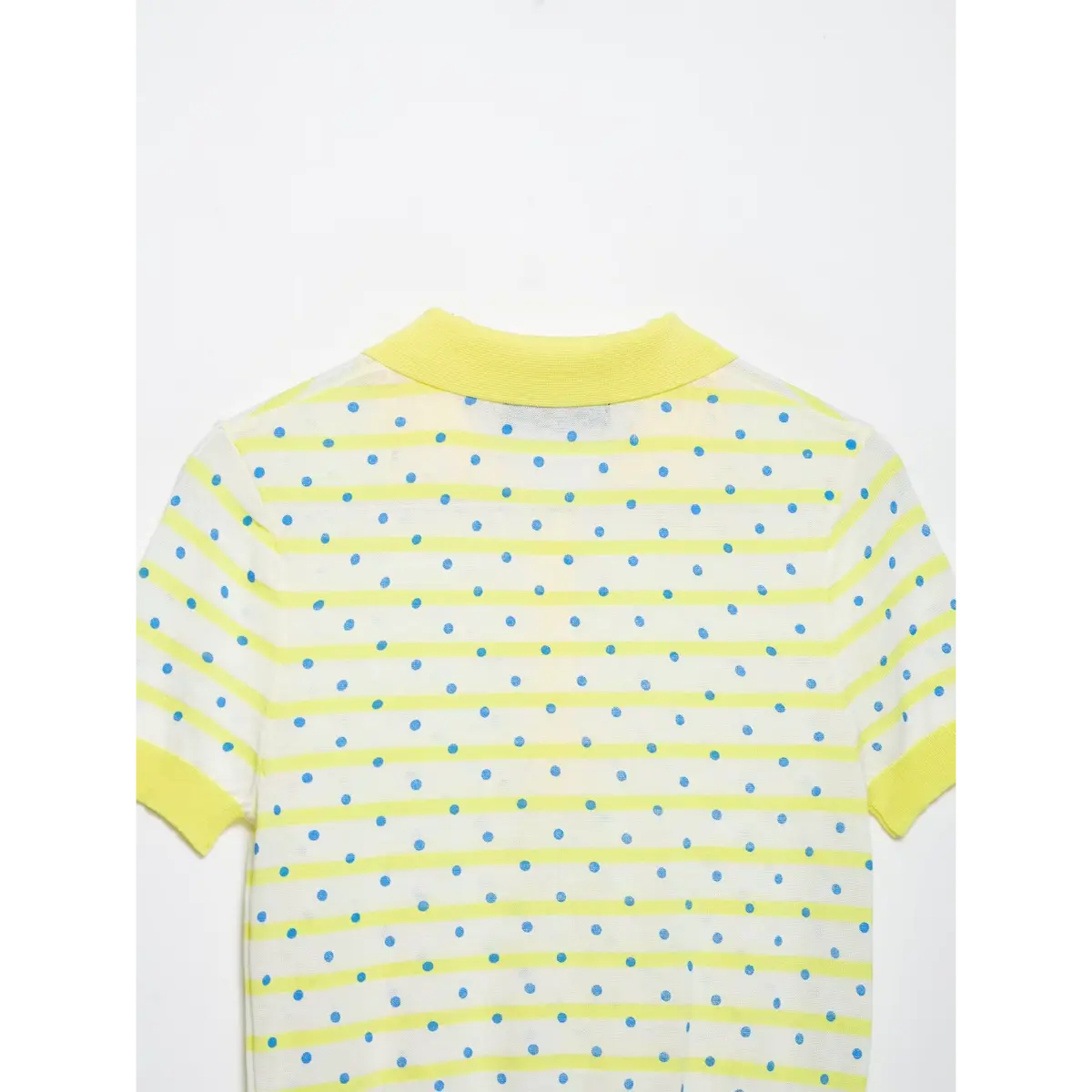 Back view of a yellow and white polka dot knit polo shirt, showing the ribbed yellow collar, striped and dotted pattern, and short sleeves.