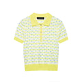 Flat lay view of a yellow and white polka dot knit polo shirt, showing the full silhouette, front placket with buttons, and ribbed trim.