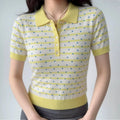 Model wearing a yellow and white polka dot knit polo shirt, showcasing the fitted silhouette, ribbed collar, and casual preppy style.