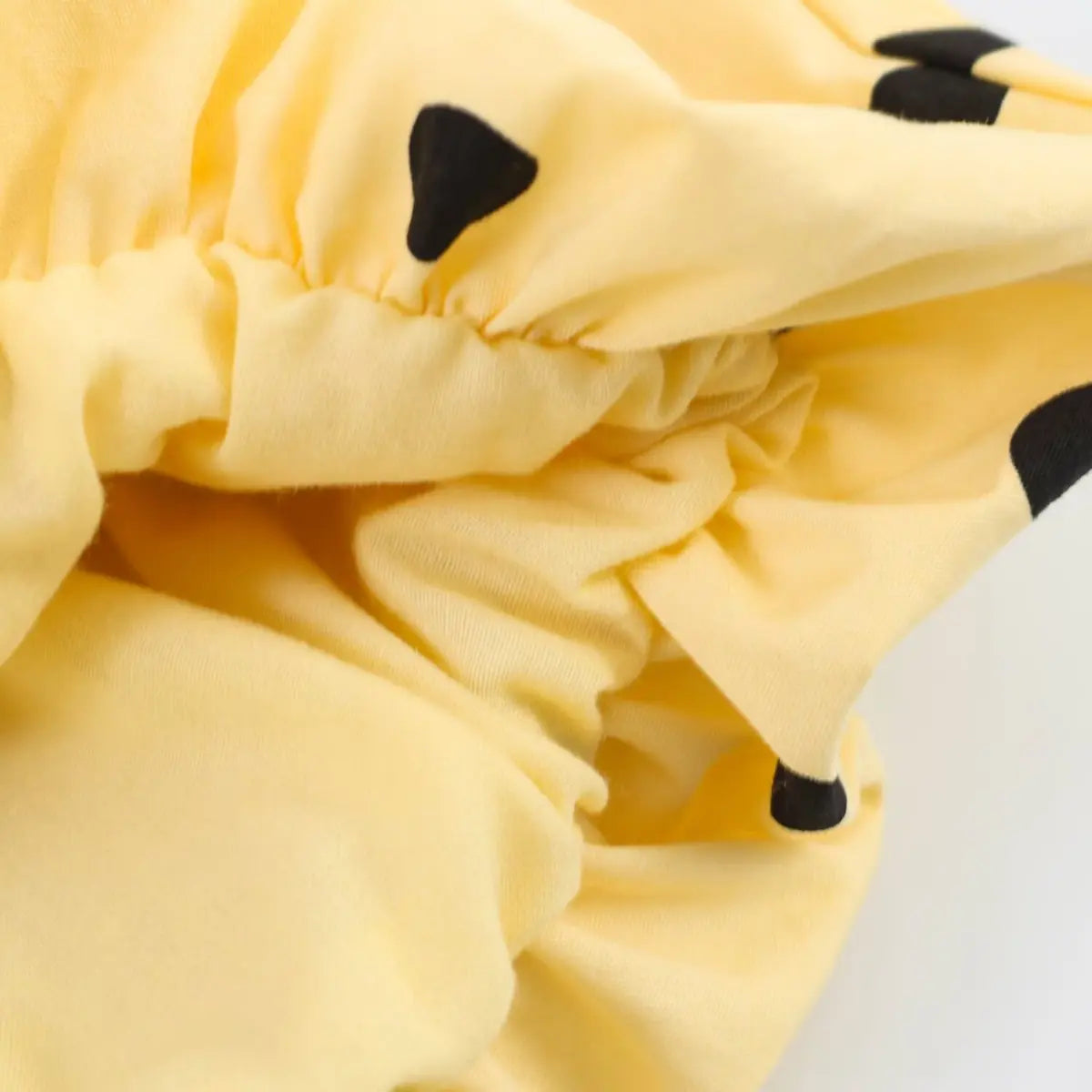 Close-up of the inner lining and fabric texture on the yellow polka dot bloomer shorts
