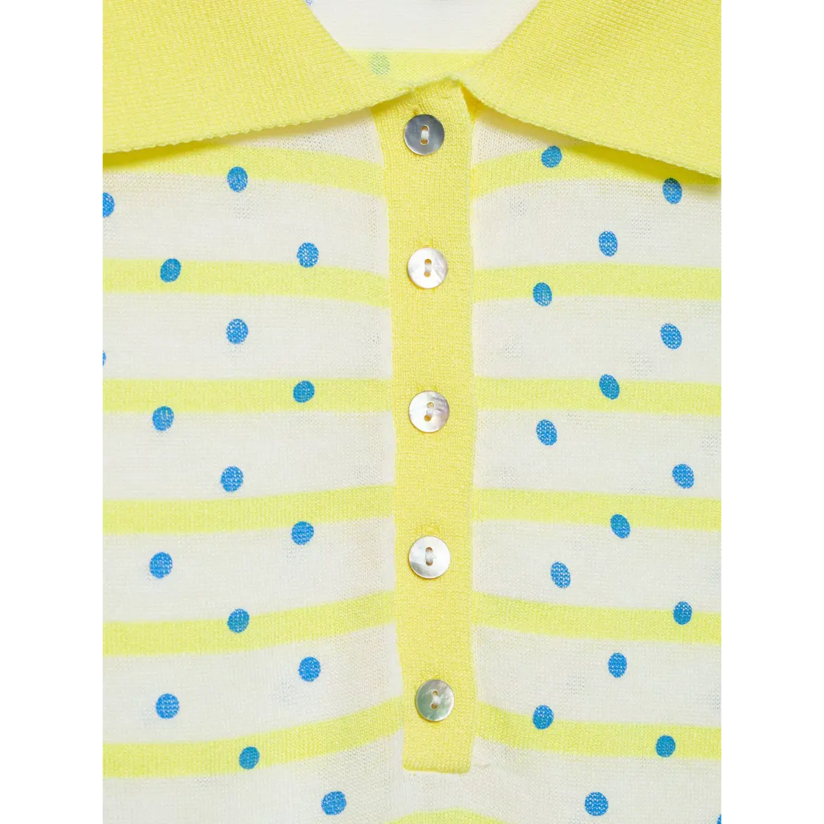 Close-up of the buttons on a yellow and white polka dot knit polo shirt, showing the mother-of-pearl finish and how they fasten to the yellow placket