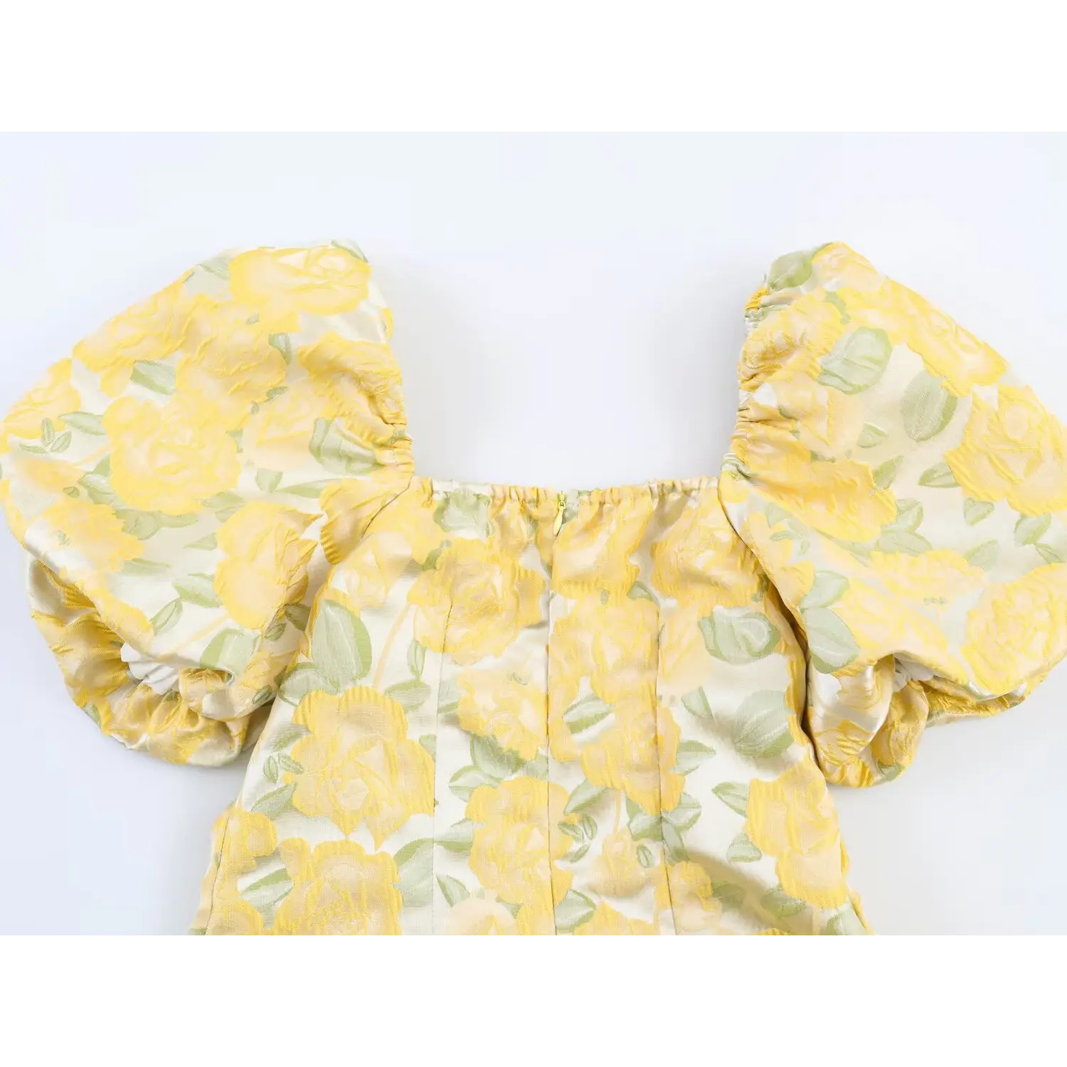 Top view of dress back featuring center zipper, square neck and puff short sleeves