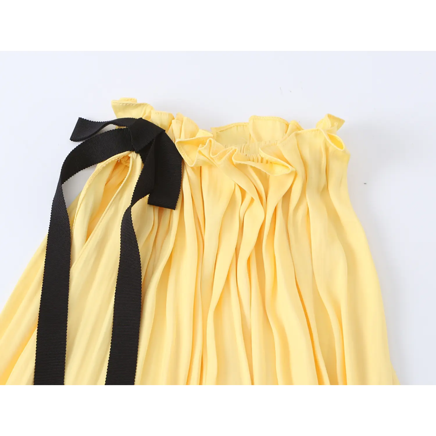 Macro neckline shot, frilled elasticated halter band, thick black ribbed grosgrain ribbon tied into adjustable bow, dense body shirring creating loose volume