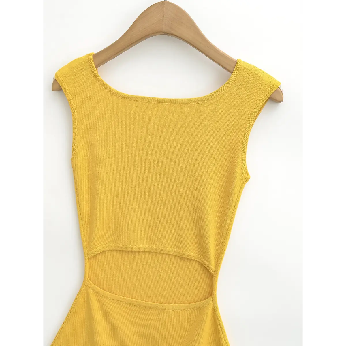 Full front shot of the yellow knit dress, showing the square neckline, cap sleeves, and midriff cutout detail.