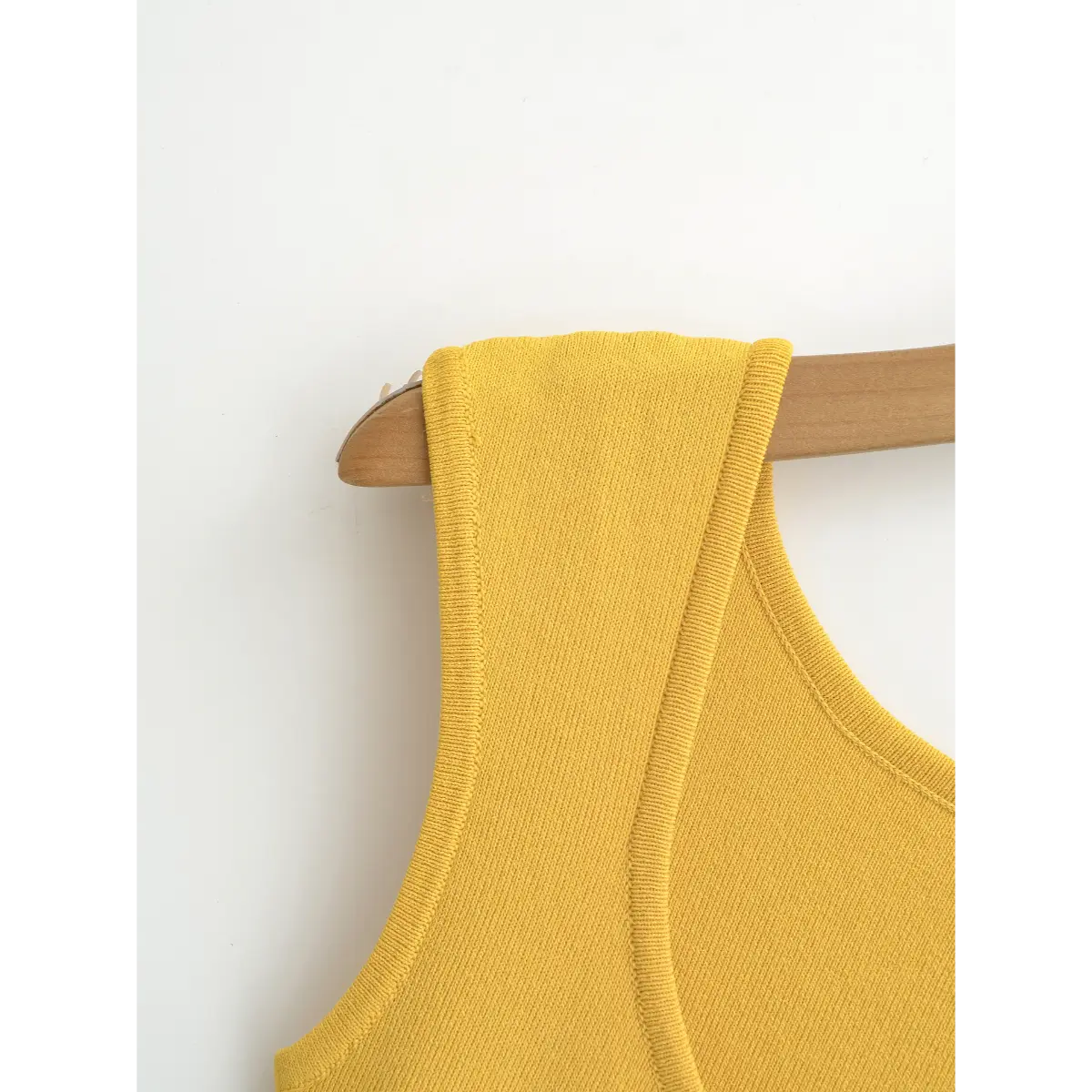 Close-up of the cap sleeve, featuring a neatly finished edge and the dress's structured shoulder seam.