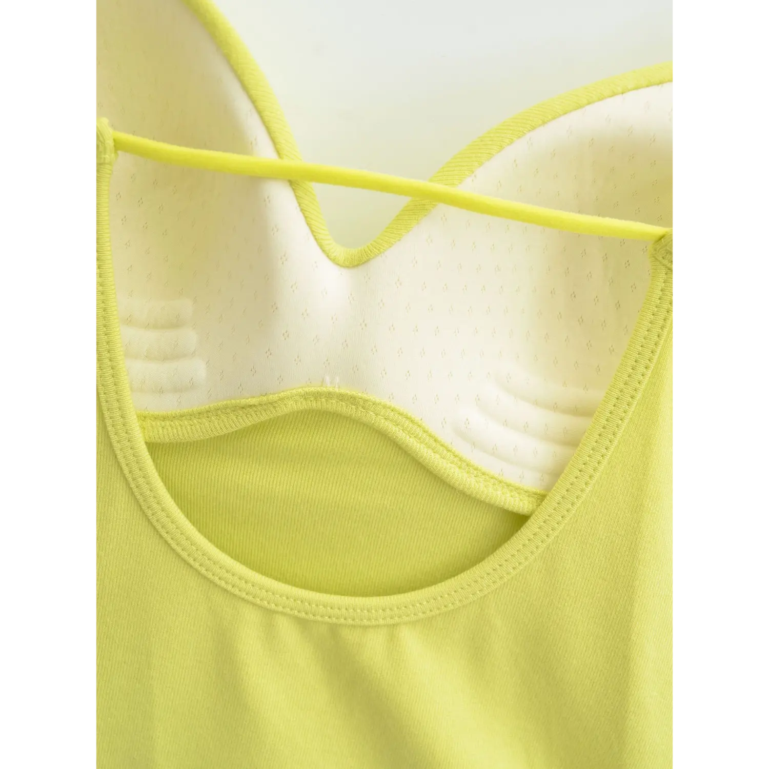 Yellow camisole front cross thin tie v neck inner flat close-up, tie strap fixed stitching scalloped v neck binding breathable padded lining white background shot