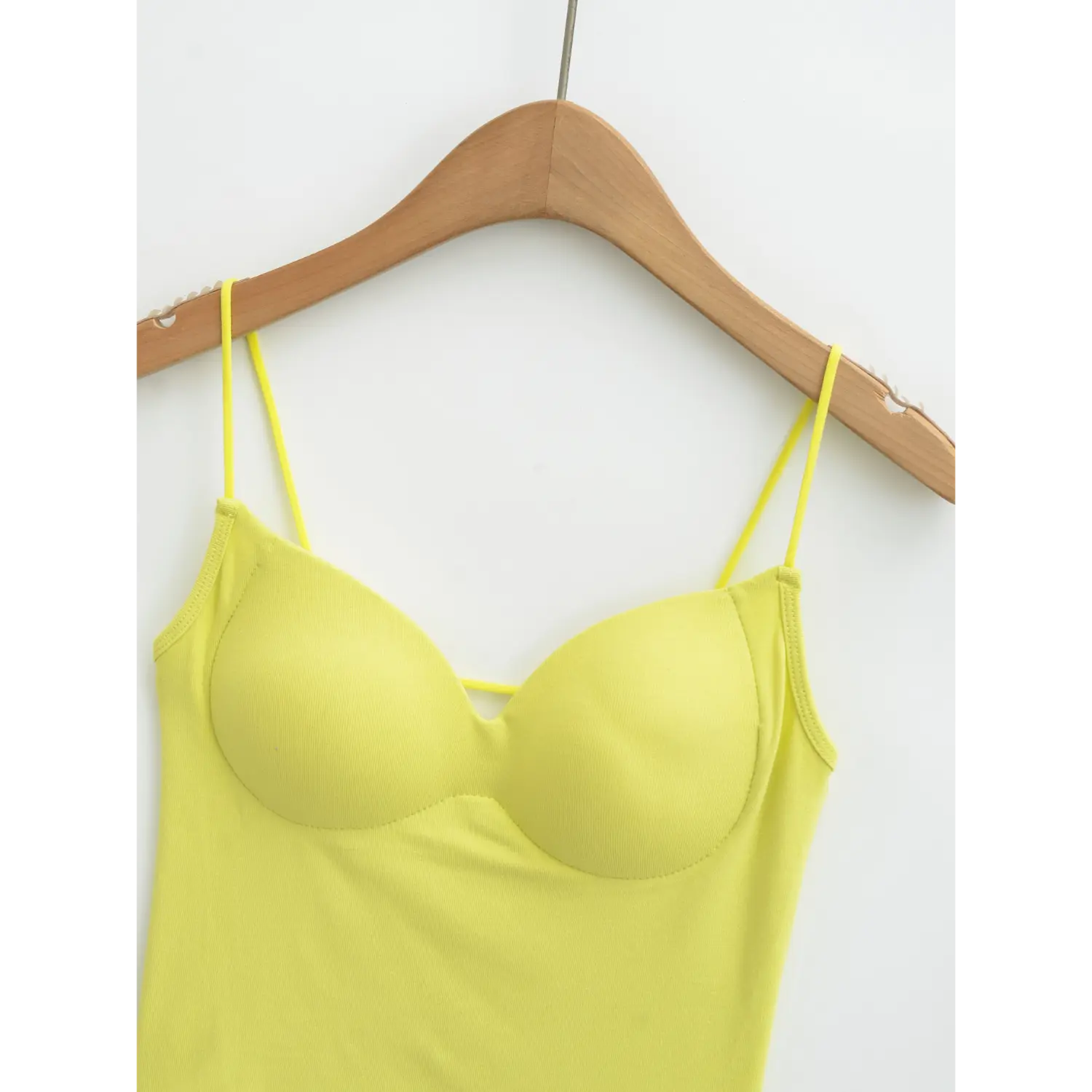 Yellow backless camisole v neck macro flat close-up, full wrap molded gathered padded bra surrounding stitching ultra thin matching straps double binding front hollow thin tie rib fabric white background detail shot