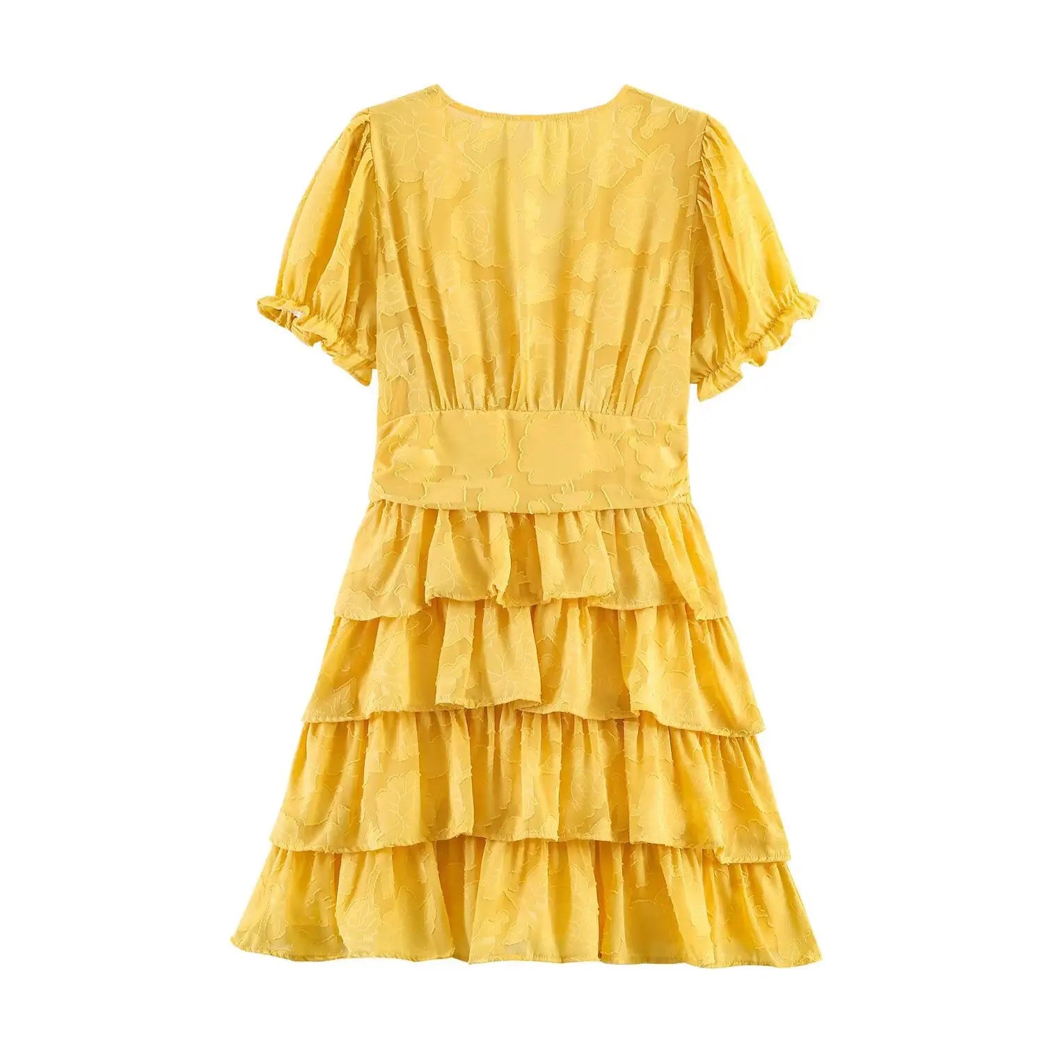 Back view of the yellow textured floral dress, showing the full silhouette and tiered skirt