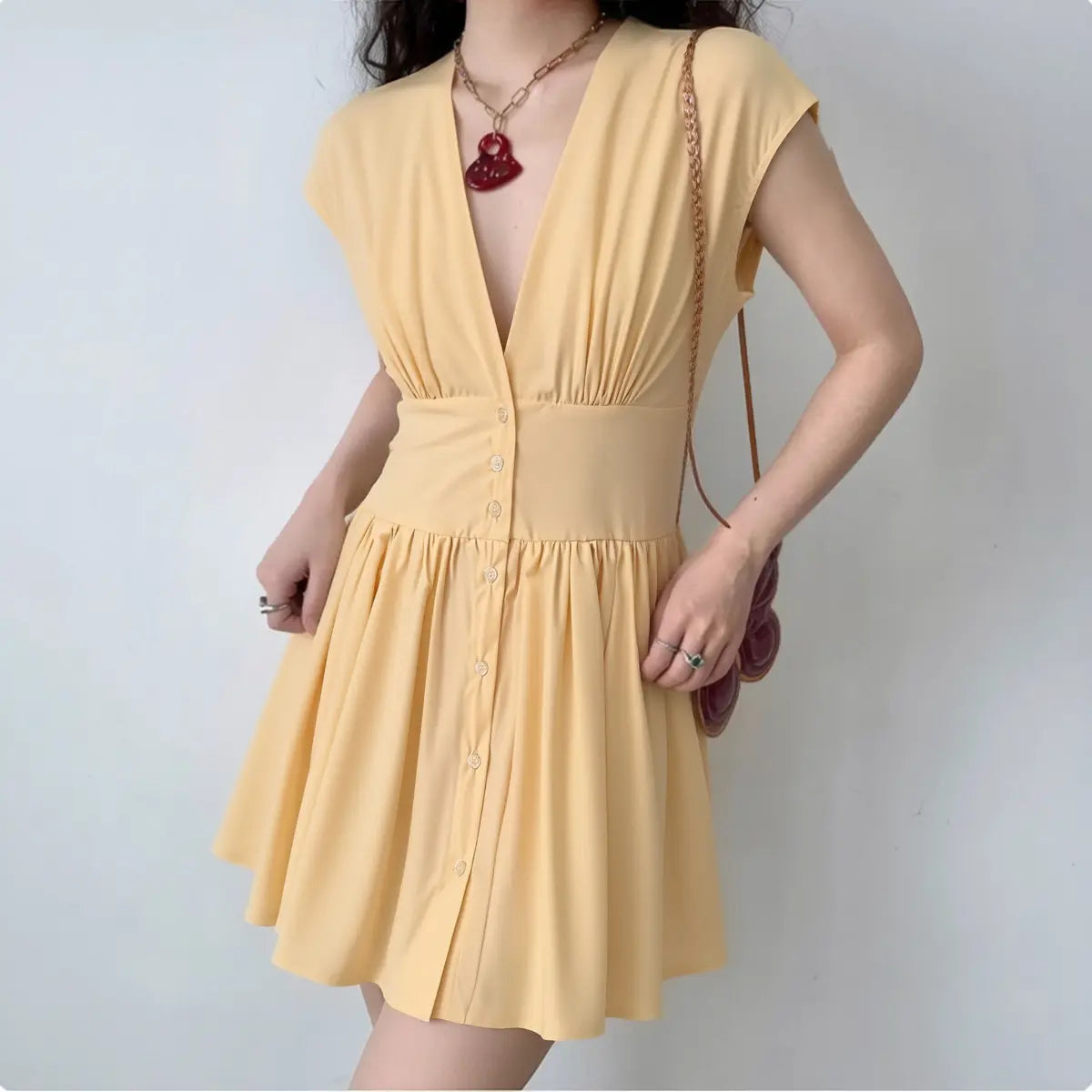 The dress styled on a model, highlighting its fit and summery silhouette.