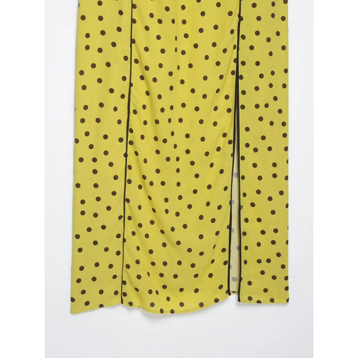Partial view of maxi skirt slit hem with polka dot pattern