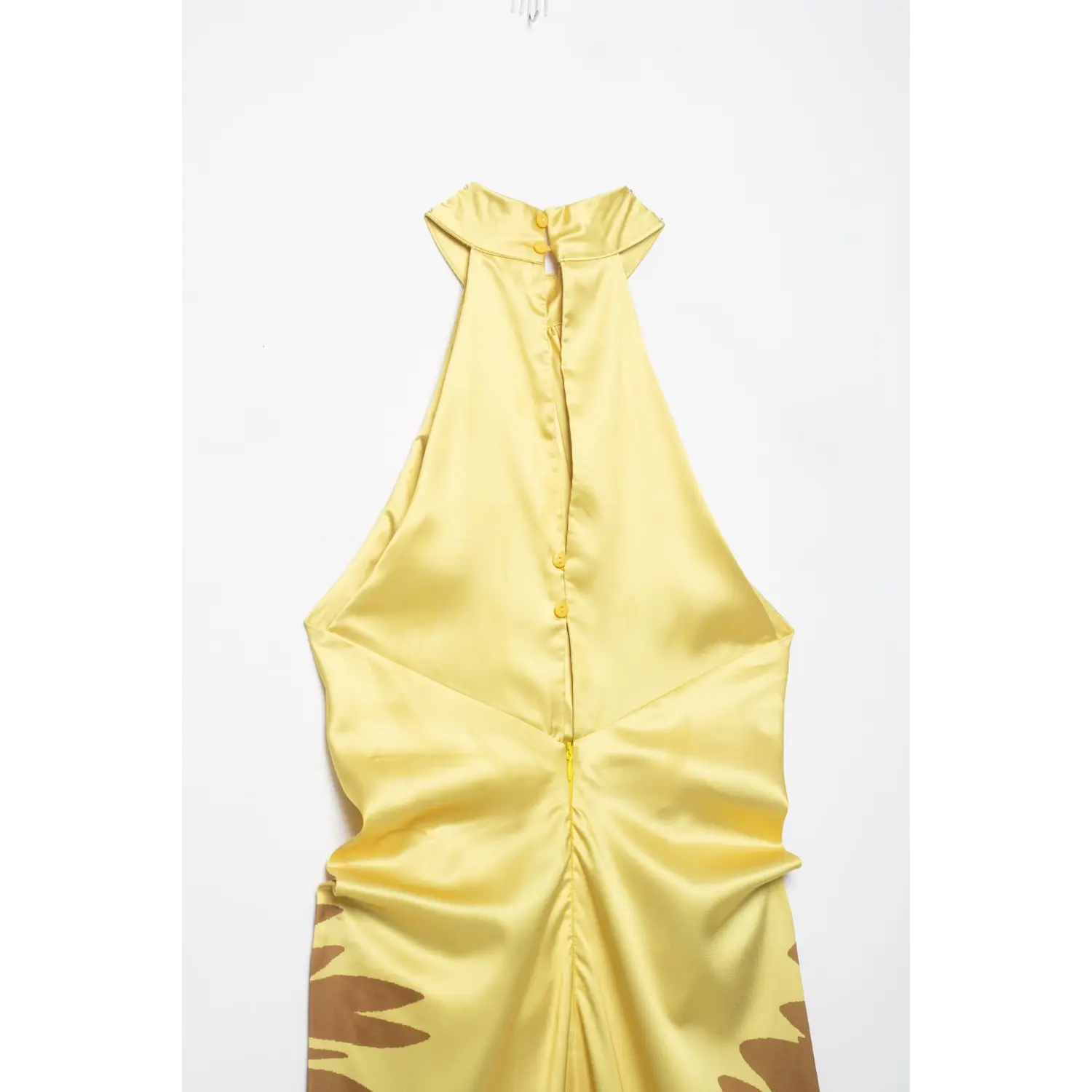 Back view flat detail of yellow satin halter maxi dress, showing halter neck buttons and center back hidden zipper