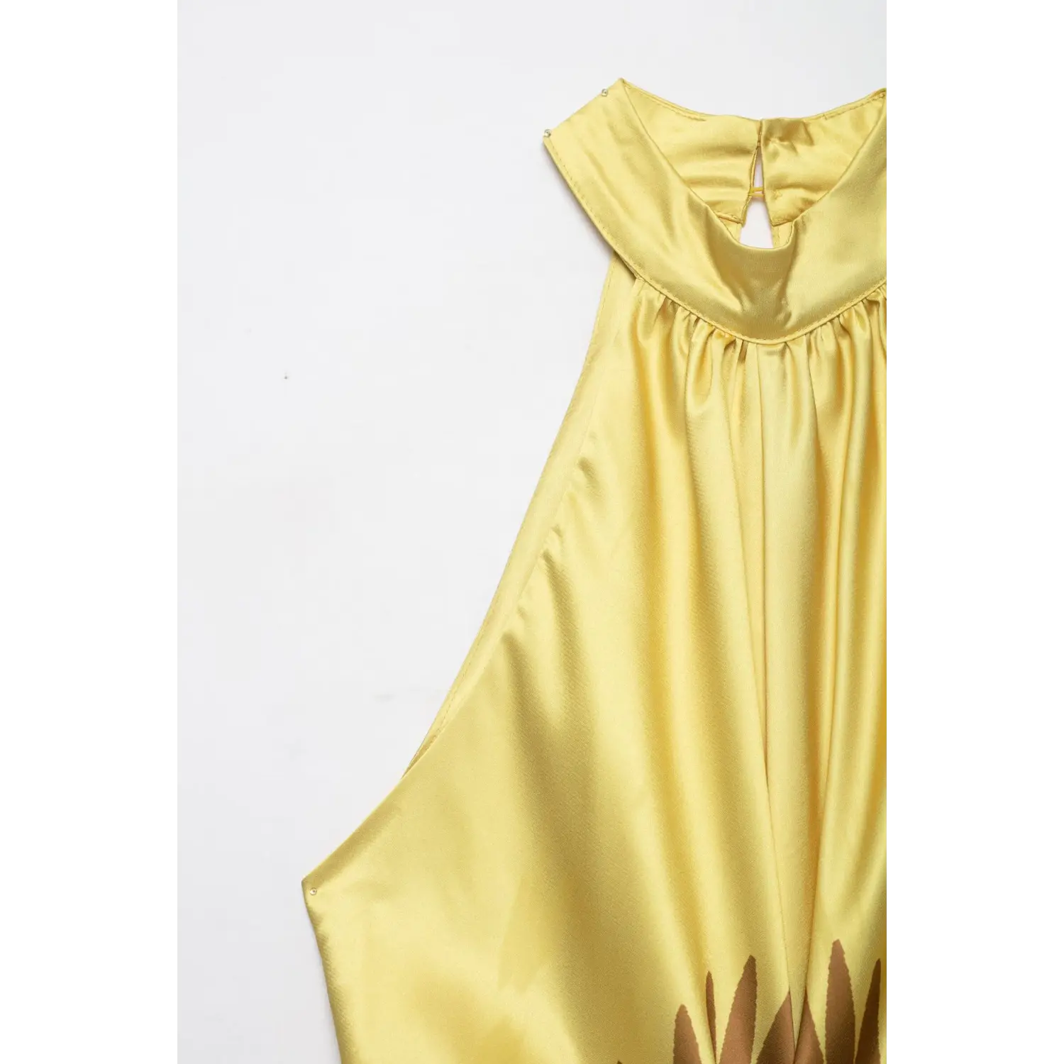 Detail shot of halter neckline on yellow satin maxi dress, keyhole cutout and gathered neck fabric