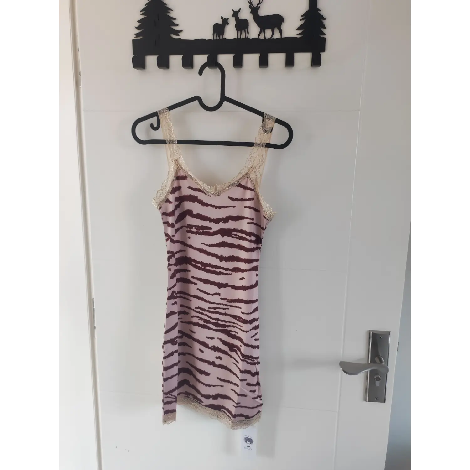 Pink zebra striped lace cami mini dress hanging on black hanger front side