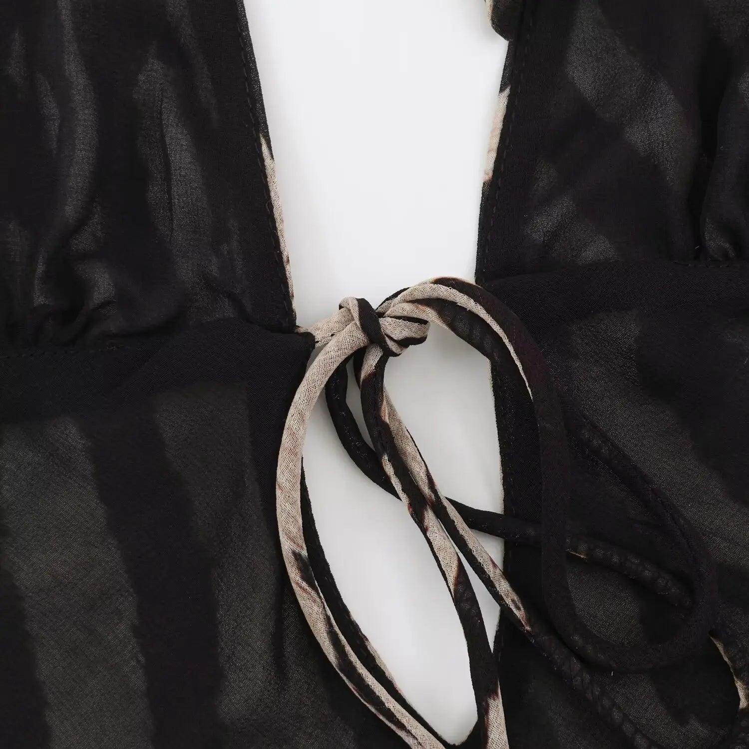 Close‑up of back tie‑up knot detail for zebra print halter maxi dress, cut‑out back lacing design