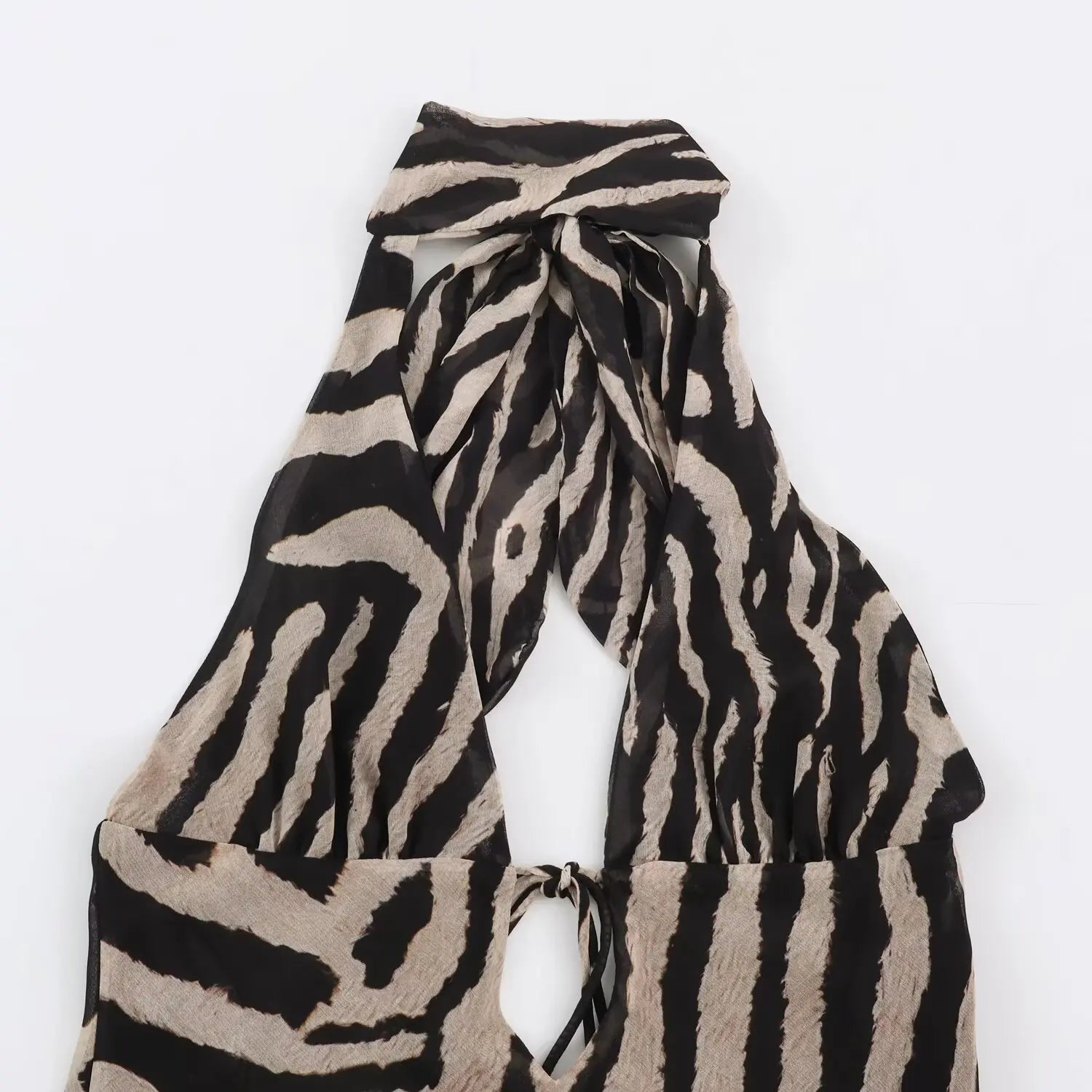 Close‑up of halter tie neck on zebra print maxi dress, back cut‑out and front tie detail
