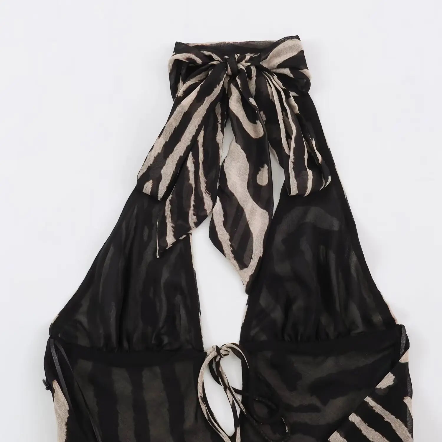 Back overall close‑up of zebra print halter maxi dress, show halter neck big bow and back tie‑up cut‑out design