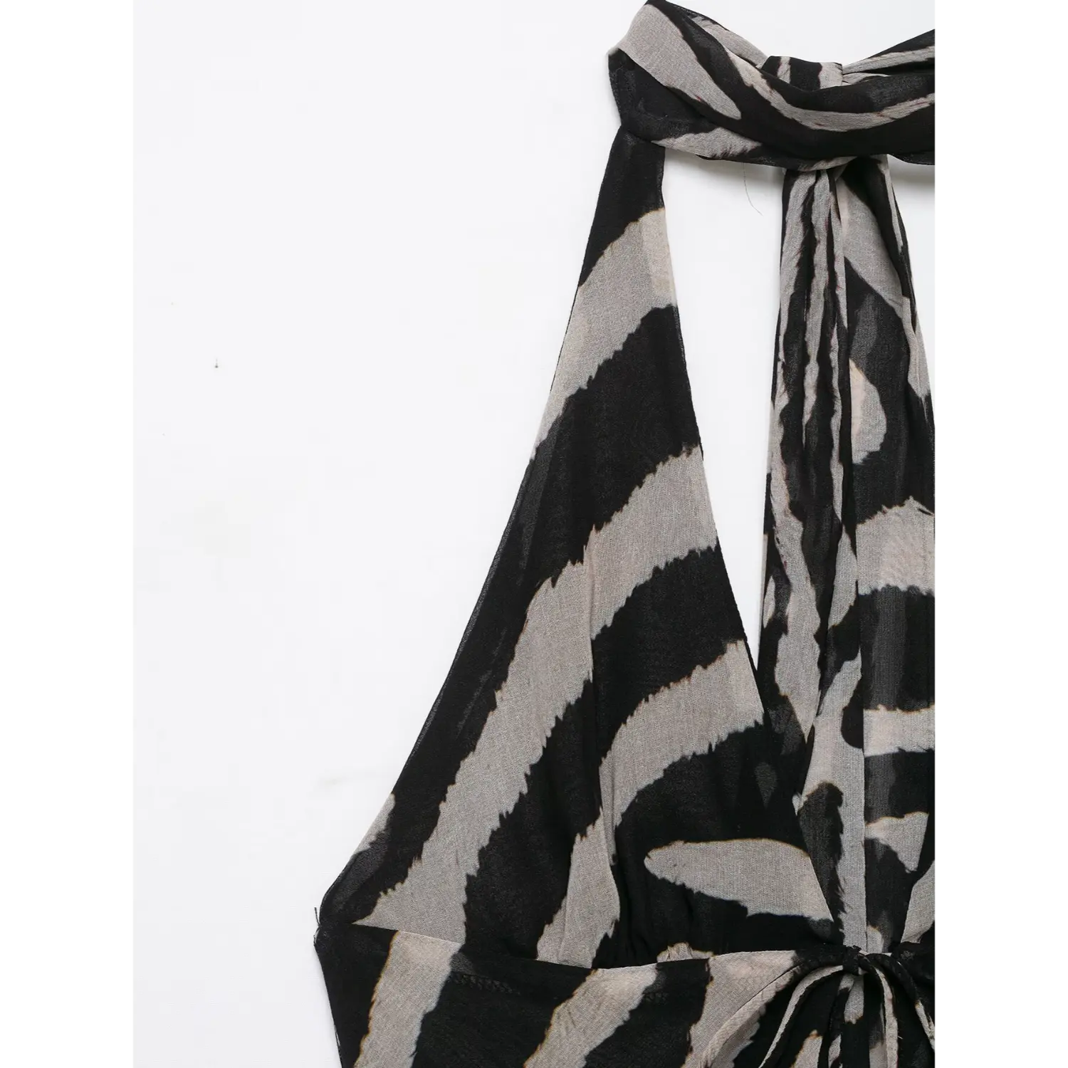 Close‑up of halter neck knotted tie and deep v neckline on zebra print sheer mesh maxi dress
