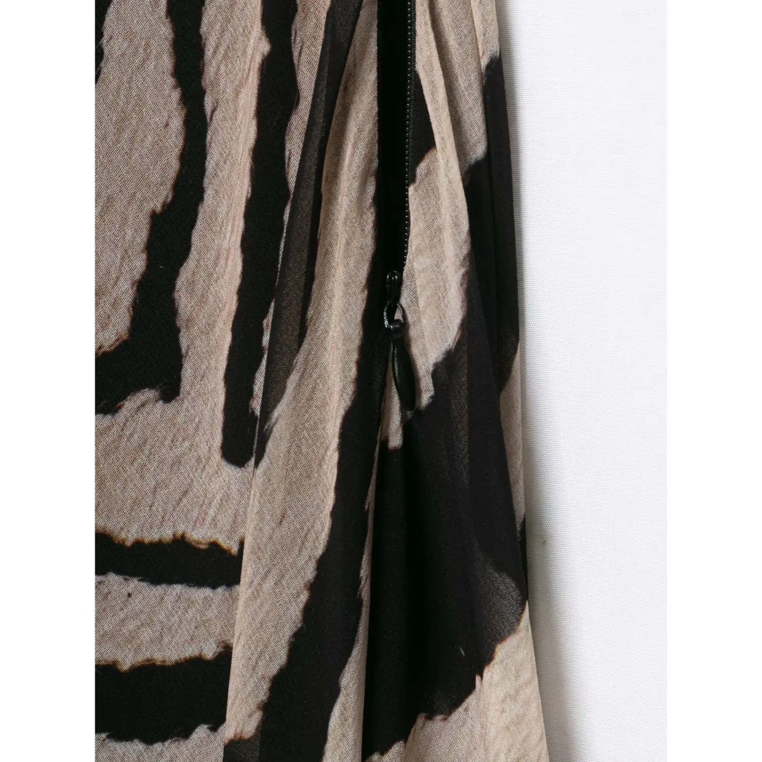 Close‑up side invisible zipper construction of zebra print halter sheer maxi long dress