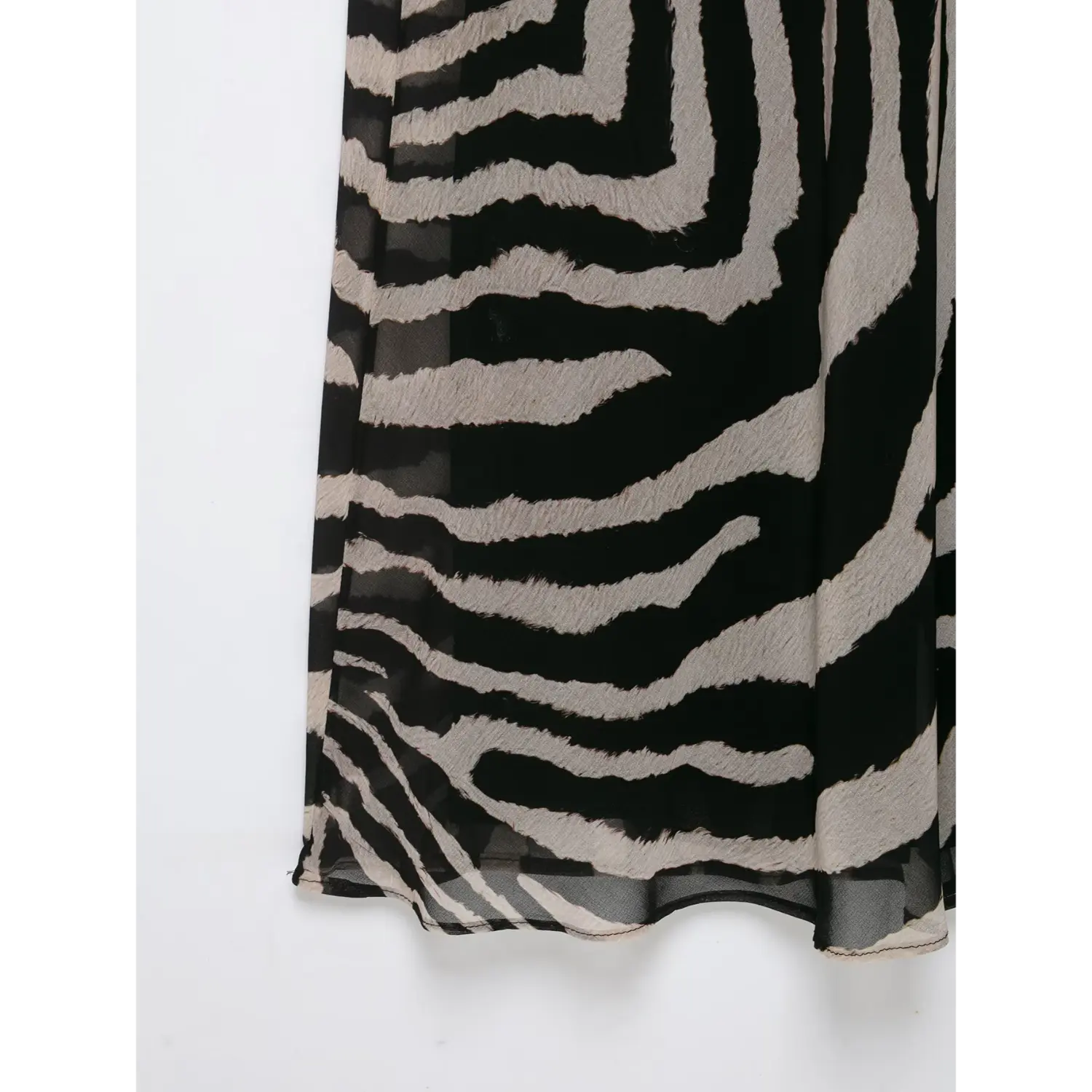 Close‑up skirt hem and sheer mesh fabric texture of zebra printed halter maxi dress